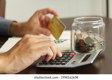 Money Management Concept. Hand Man Use Calculator To Calculate The Budgets To Pay Off Credit Card Dept.