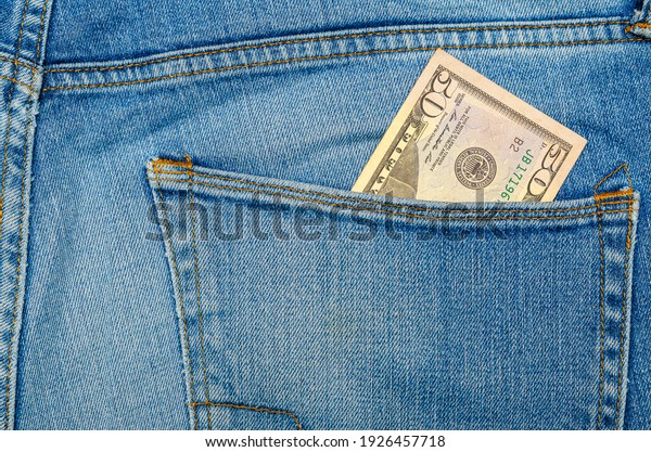 Money in my jeans pocket, fifty dollars in the back\
pocket of blue jeans. Wealth and prosperity concept. Place for\
text. Copy space