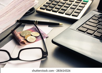 Money on bills with laptop and calculator