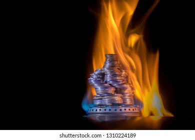 Money Is On Fire. The Concept Of High Prices For Natural Gas. Blue Flame Of Burning Natural Gas From A Gas Stove With Ukrainian Coins