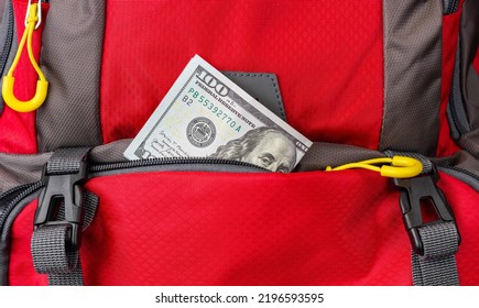 Money Peeking Out Of A Backpack Pocket. A Dollar Bill Falls Out Of A Backpack Pocket. Pickpocket Lure.