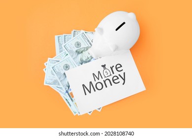 Money, Piggy Bank And Paper Sheet With Text MORE MONEY On Color Background