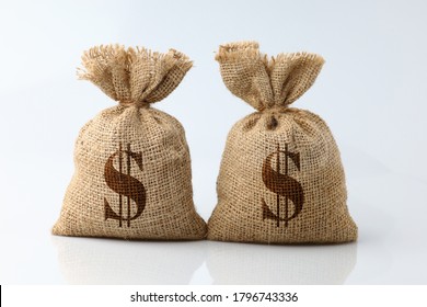 Money in sack 2 bags with wooden model house isolated on white background. Concept saving money for planning business accounting, investment for success in the future.