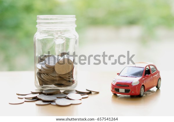 Money\
saving for Car installment in the glass\
bottle