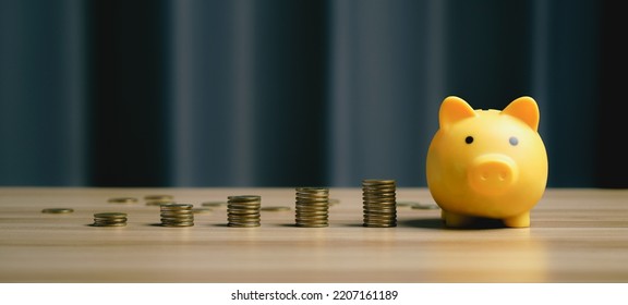 Money Saving Concept. Pile Of Coins, Piggy Bank And On Desk Background, Long Term Investment For Retirement. Interest Rate And Dividend. Tax, Inflation, Wealth. Financial Business Background
