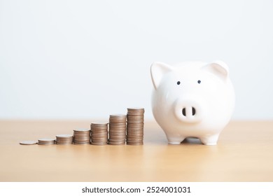 Money Saving for Future Plan, Retirement fund, Pension, Investment, Wealth Business and Financial concepts. hand putting coin into piggy bank on table, Money Counting and stack arrangement for deposit