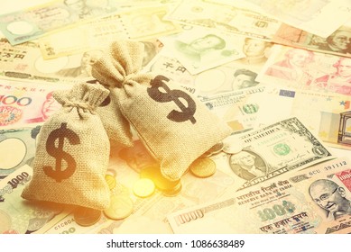 Money saving, investment and rich or wealth management concept : US dollar or cash in hemp bags or burlap sacks and coins, depicts prosperous person or millionaire has a lot of money. Notes background - Shutterstock ID 1086638489
