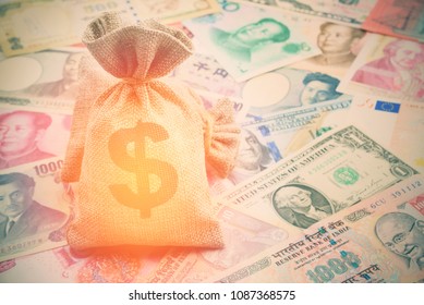 Money Saving, Investment And Rich Or Wealth Management Concept : Dollar Or Cash In Hemp Bags Or Burlap Sacks And Coins On Yen, Yuan Bills, Depicts Prosperous Person Or Billionaire Has A Lot Of Money. 