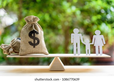 Money Saving For Kids, Family Financial Wealth Management Concept : Dollar Or Cash In Hemp Bags Or Burlap Sacks And A White Paper Cut (dad, Mom And Son) On Wood Balance Scale. Green Nature Background.