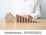 Money Saving, Property investment, House Mortgage and Real Estate Financial concepts. coins stack with Home model, Money stack Counting arrangement for deposit and Tax