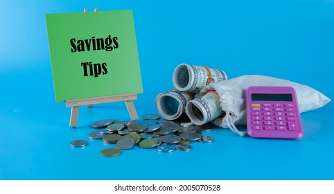 Money Saving Tips Concept. Selective Focus On The Green Board  With A Text Saving Tips. How To Save Money Fro Holiday, Paying Loan Or Investment Concept