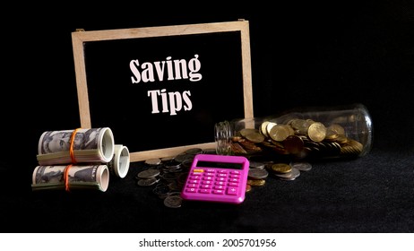 Money Saving Tips Concept. Selective Focus On The Green Board  With A Text Saving Tips. How To Save Money Fro Holiday, Paying Loan Or Investment Concept