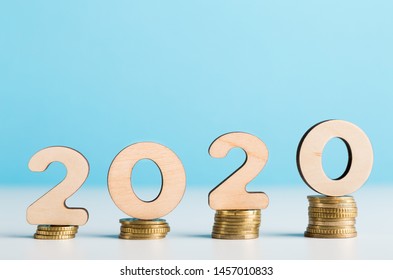 Money Savings Concept. Big 2020 Wooden Numbers On Coins Showing Financial Growth, Copy Space