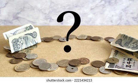 Money scattered in a circle and question marks in marble background oblique