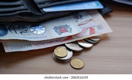 Money, Singapore dollars (SGD), banknote and coins on a wallet on table - traveling conceps. Jakarta, 25 October 2021