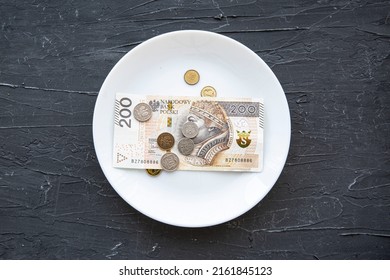 Money Spend On Food Concept In Poland On Black Backgorund. Poland Zloty In Plate.