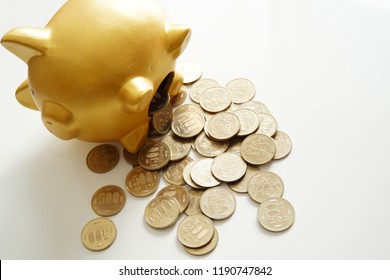 Money spilling out of the piggy bank. - Shutterstock ID 1190747842