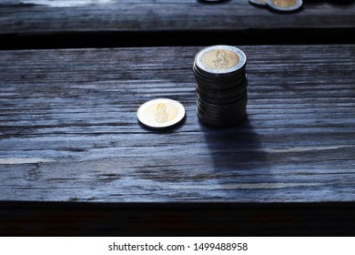 money stack is put together on old wood background