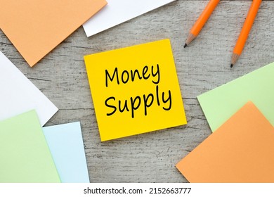 Money Supply Text On Orange Sticky Note On Wooden Background