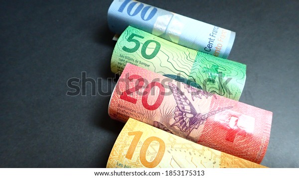 Money; Swiss franc (chf)\
banknote on black background. Business,finance, Investment and\
economy concept.
