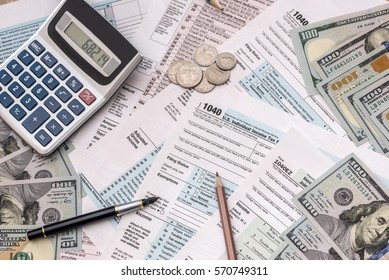 Money, Tax Form, Calculator And Pen On Desk.