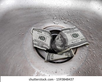 Money is thrown away in the sink. This photo concept illustrates the financial condition of a business that is failing or going bankrupt so that it only wastes money without results.


