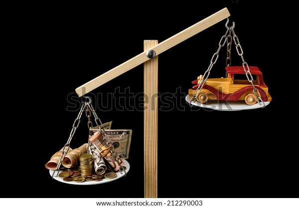 Money and Toy\
Wooden Car on a Two Pan\
Balance
