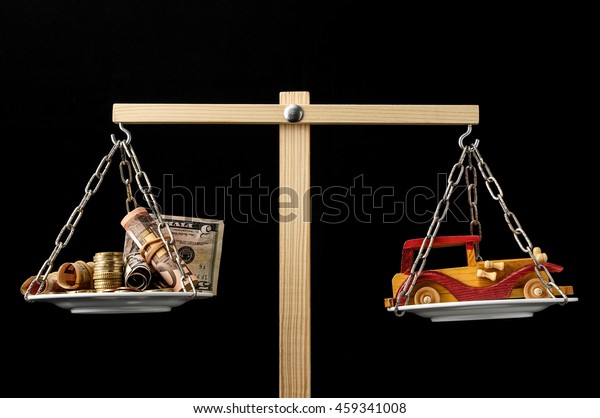 Money and Toy\
Wooden Car on a Two Pan\
Balance