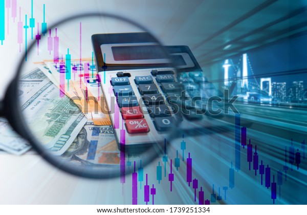 Money under\
a magnifying glass. Calculator near the night city. Concept -\
economic downturn. Reducing the GDP of developed countries. The\
falling chart symbolizes the economic\
crisis.