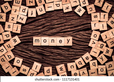 Money word written cube on wooden background. Vintage concept.