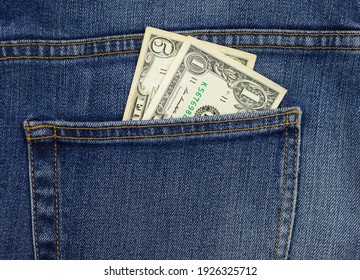 Money In Your Pocket. Dollar Bills In The Back Pocket Of Jeans. The Concept Of Pocket Money. Cash. American Money Of Various Denominations.