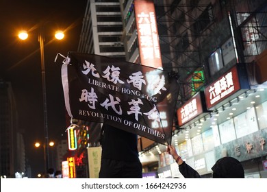 Mong Kok, Hong Kong - 29 Feb 2020: Protestors Holding The Flag With Slogan