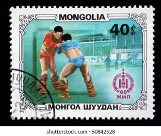 MONGOLIA - CIRCA 1981: A Post Stamp Printed In Mongolia Shows Two Wrestlers At The Event On The Traditional Wresling, Series Honoring 60 Years Of Mongolian Peoples Republic, Circa 1981