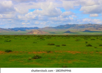 Mongolia Steppe Landscape Of Infinite Grasslands Under Beautiful Cloud In Blue Sly