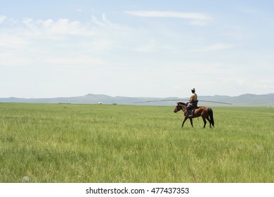 A Mongolian Herder And The Boundless Steppe.