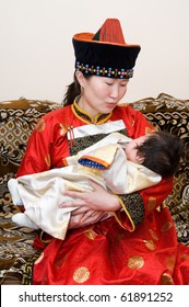 Mongolian Woman Rocks Her Baby To Sleep