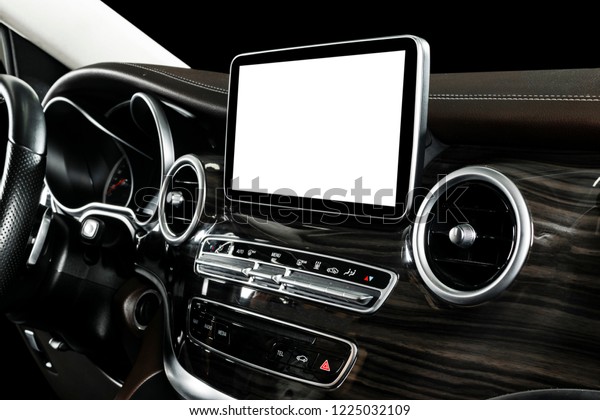 Monitor in car with isolated blank
screen use for navigation maps and GPS. Isolated on white with
clipping path. Car detailing. Modern car interior
details.