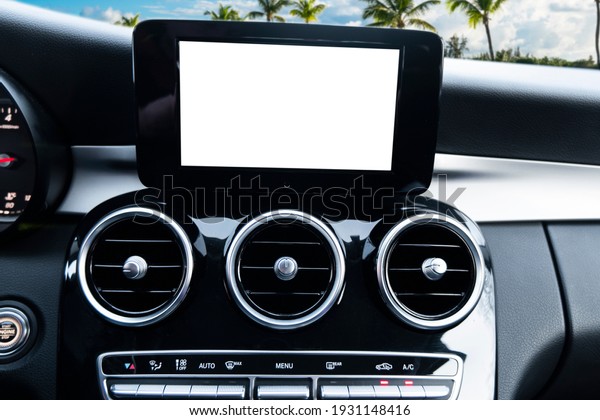 Monitor in car with isolated blank screen use\
for navigation maps and GPS. Isolated on white with clipping path.\
Car detailing. Car display with blank screen. Modern car red\
leather interior\
details.