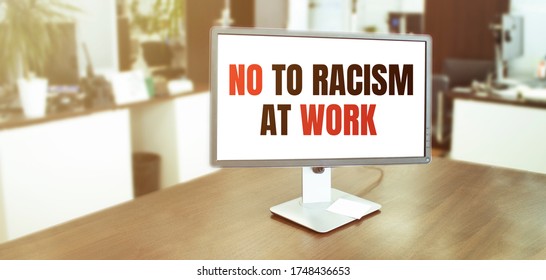 Monitor In Modern Office With NO TO RACISM AT WORK Text On The Screen