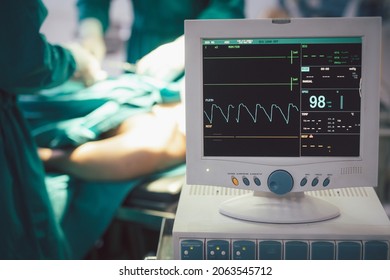 Monitor Screen For A Medical Defibrillator Or Emergency Heart Pump, Showing Vital Signs, Heart Rate, Slow Beating Pulse Of A Dying Coma Patient In A Hospital ICU Room