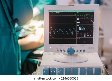 Monitor Screen For A Medical Defibrillator Or Emergency Heart Pump, Showing Vital Signs, Heart Rate, Slow Beating Pulse Of A Dying Coma Patient In A Hospital ICU Room