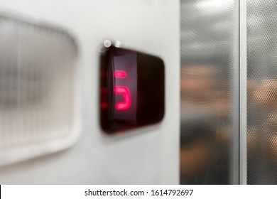 Monitor show number floor in elevator. Extreme close-up. It can be used to express concepts such as: claustrophobia, panic attack, malaise.