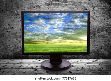 monitor with thea picture of of pure field against the gray walls