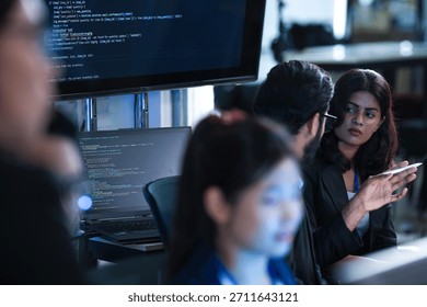 Monitoring AI training progress. Specialists oversee a machine learning model's training observing real time metrics on screen discussing adjustments via tablet interface late night.