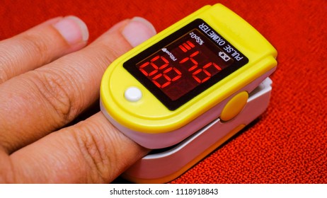 Monitoring Corona Patient Status From The Finger. Oxygen Saturation And Heart Rate With A Pulse Oximeter.   Blood Oxygen Levels Is Displayed On The Device. The Patient Suffers From Oxygen Deficiency
