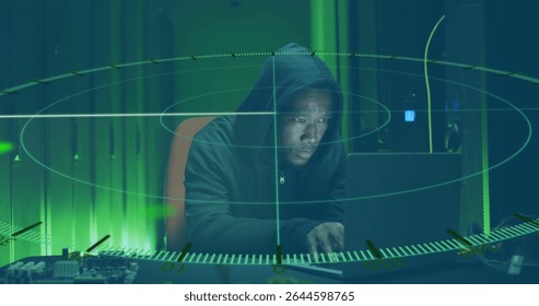 Monitoring hacker in hoodie scanning laptop and circuit board in data center, holographic overlay. Tech, cybersecurity, futuristic, digital, industrial, high-tech, intensity
