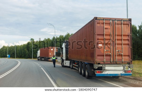 Monitoring the movement of heavy vehicles on the\
highway. blurred\
focus