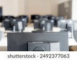 Monitors and keyboard in an empty computer lab at a secondary school.