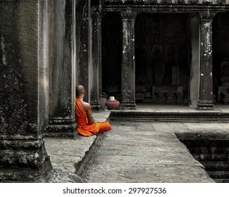 A monk meditates at the Angkor Wat temple in Siem Reap Cambodia. - Powered by Shutterstock