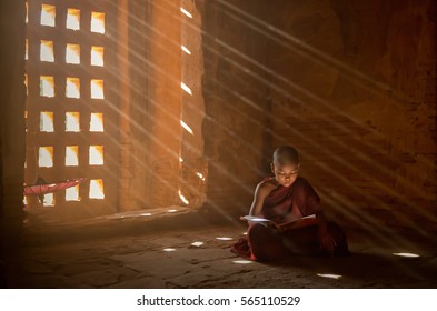 Monk reading with sun light from outside to inside, Bagan Myanmar